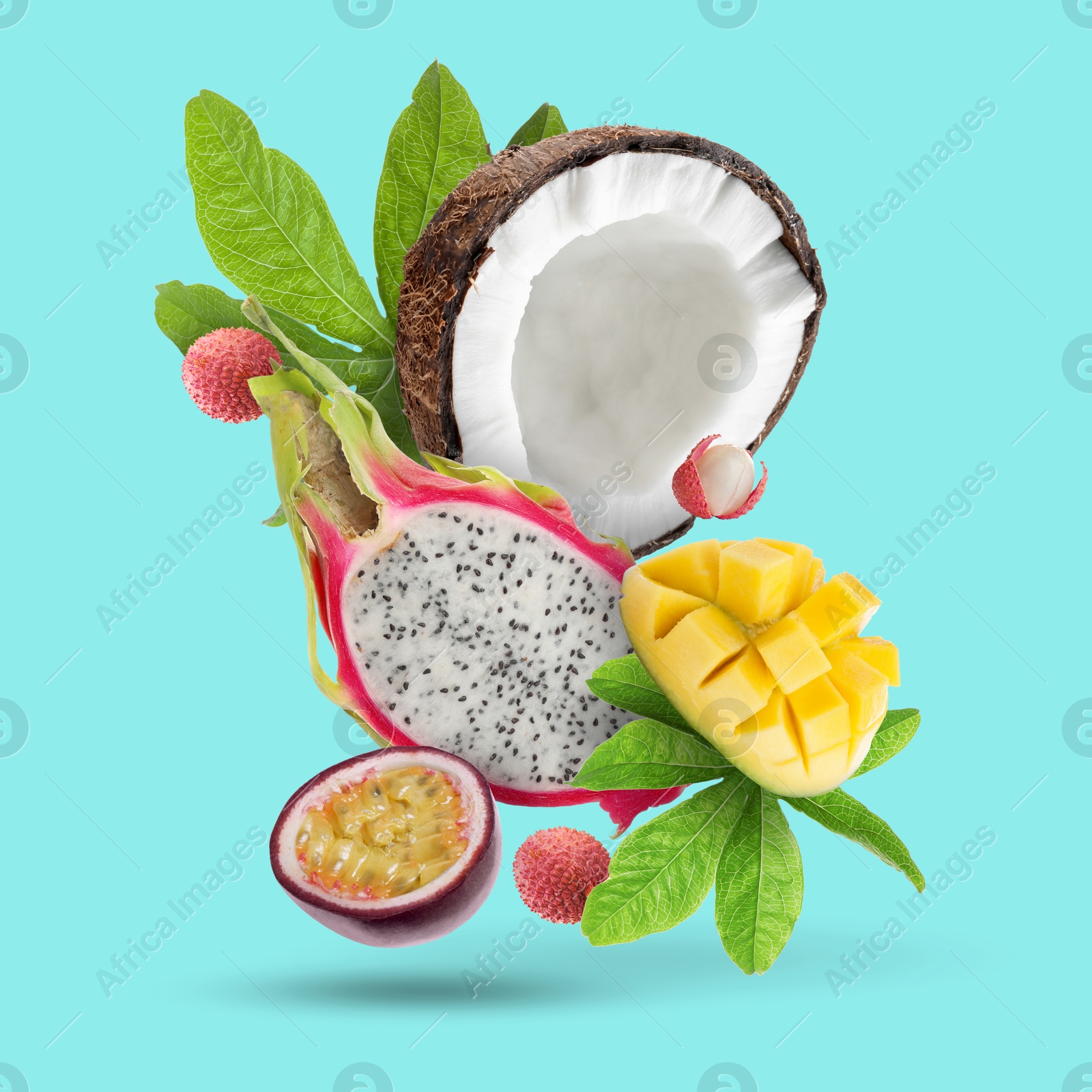 Image of Coconut, dragonfruit, mango, lychees and maracuja in air on turquoise background. Tropical fruits