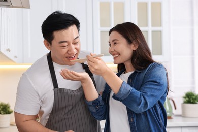 Photo of Happy lovely couple cooking together in kitchen