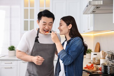 Photo of Happy lovely couple cooking together in kitchen