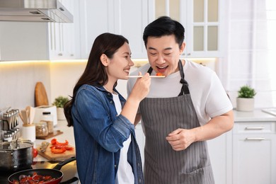 Photo of Happy lovely couple cooking together in kitchen