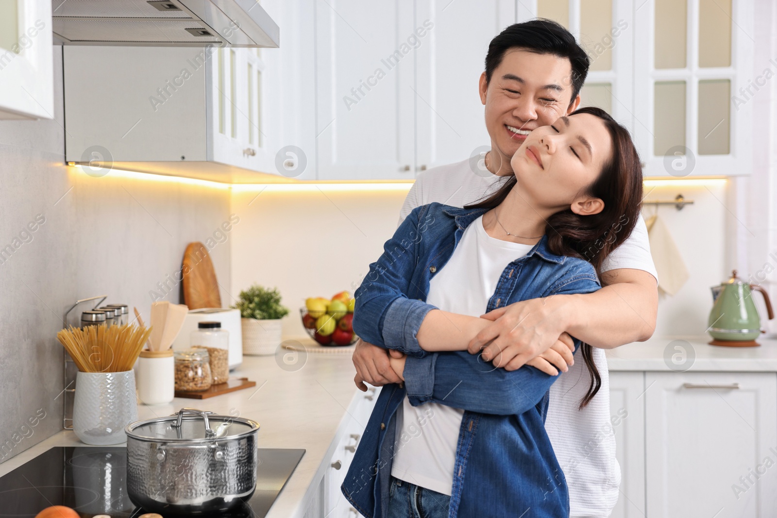 Photo of Lovely couple enjoying time together while cooking in kitchen