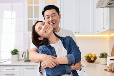 Lovely couple enjoying time together in kitchen