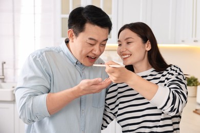 Photo of Happy lovely couple cooking together in kitchen