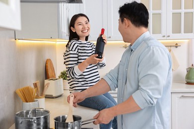 Photo of Happy lovely couple cooking together in kitchen