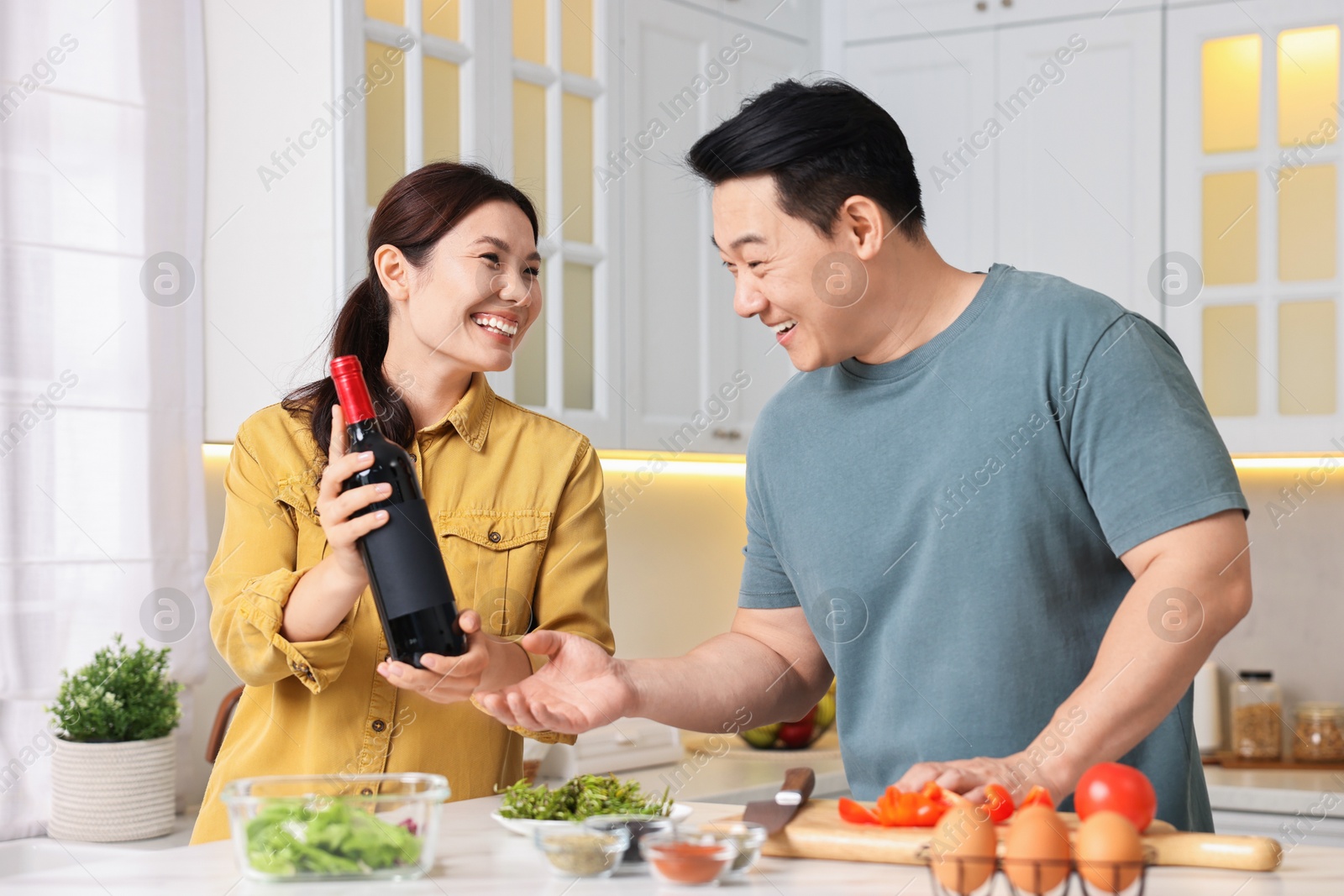 Photo of Happy lovely couple cooking together in kitchen