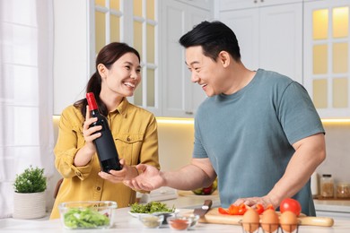 Photo of Happy lovely couple cooking together in kitchen