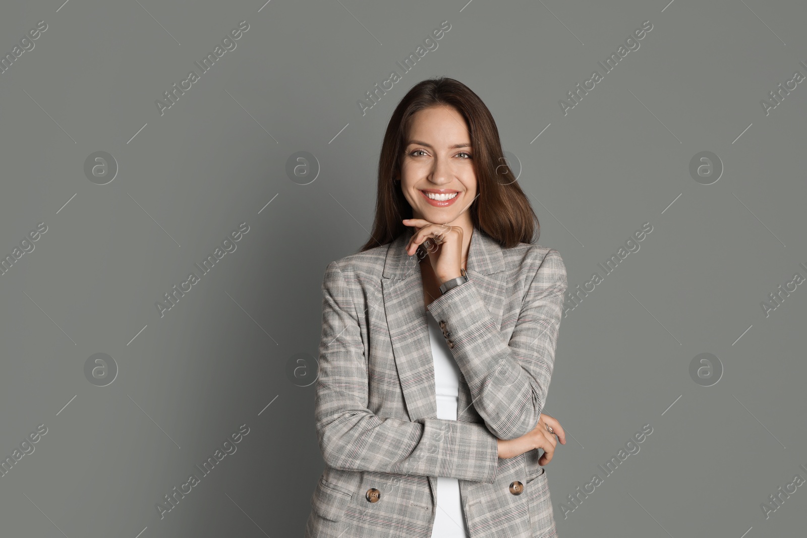 Photo of Beautiful woman in stylish jacket on grey background