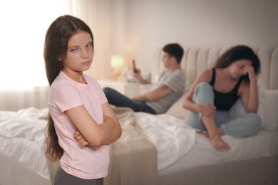 Photo of Divorce concept. Sad couple in bedroom, focus on their unhappy daughter