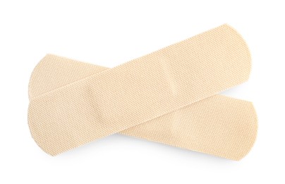 Photo of Medical adhesive bandages isolated on white, top view
