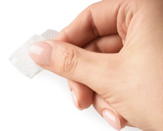 Photo of Woman putting medical adhesive bandage on white background, closeup