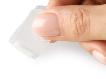Photo of Woman putting medical adhesive bandage on white background, closeup