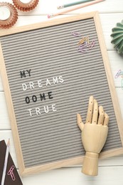 Photo of Flat lay composition of letter board with phrase My Dreams Come True on white wooden table