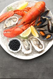 Different sea food on grey table, top view