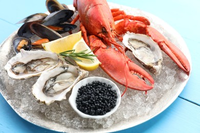 Photo of Many different sea food on light blue wooden table, closeup