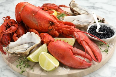 Many different sea food on white marble table, closeup