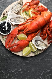 Photo of Many different sea food on dark table, top view