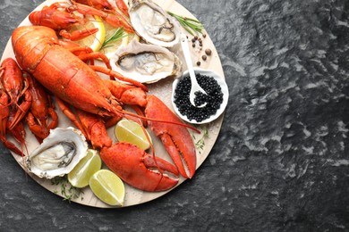 Many different sea food on dark table, top view