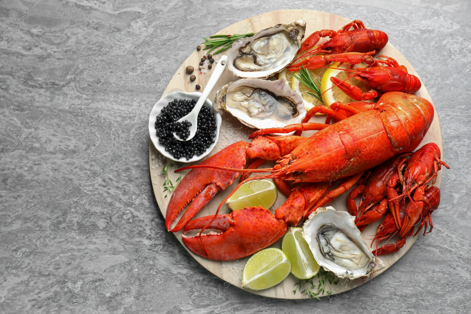 Photo of Many different sea food on grey table, top view