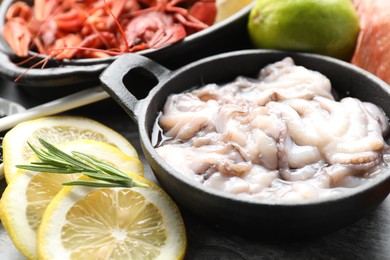 Photo of Raw squids, crayfishes and spices on table, closeup