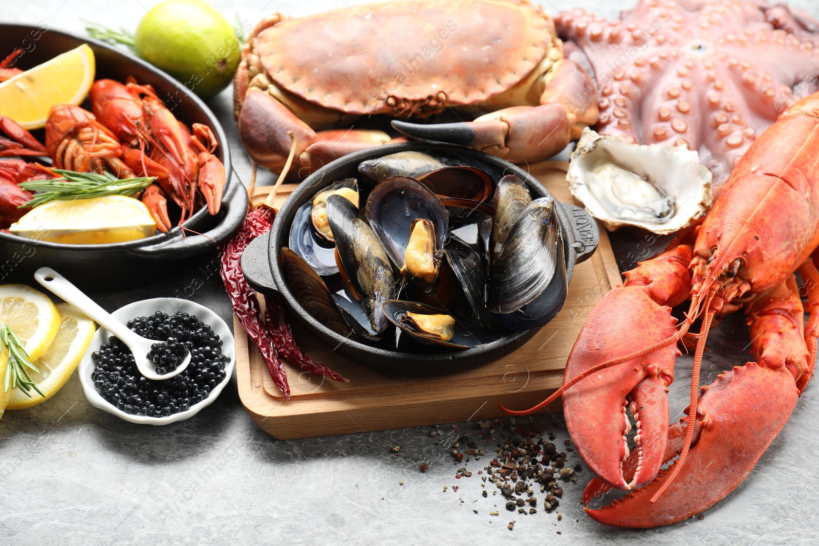 Photo of Many different sea food on grey table