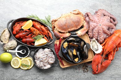 Photo of Many different sea food on grey table, top view