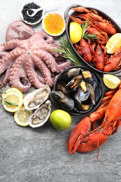 Photo of Many different sea food on grey table, top view