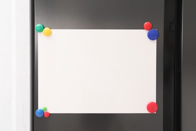 Photo of Blank note board with magnets on refrigerator in kitchen. Mockup for design