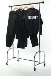 Security guard's uniform on clothing rack isolated on white