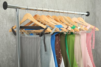 Photo of Aprons on clothing rack near light grey wall