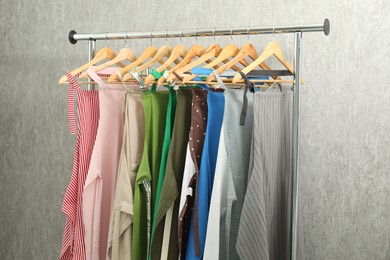 Photo of Aprons on clothing rack near light grey wall