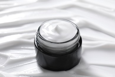 Jar with face cream, closeup. Cosmetic product