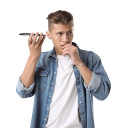 Photo of Young man with smartphone listening to voice message on white background