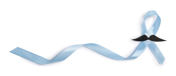 Photo of Light blue ribbon and fake mustache isolated on white, top view. Prostate cancer awareness