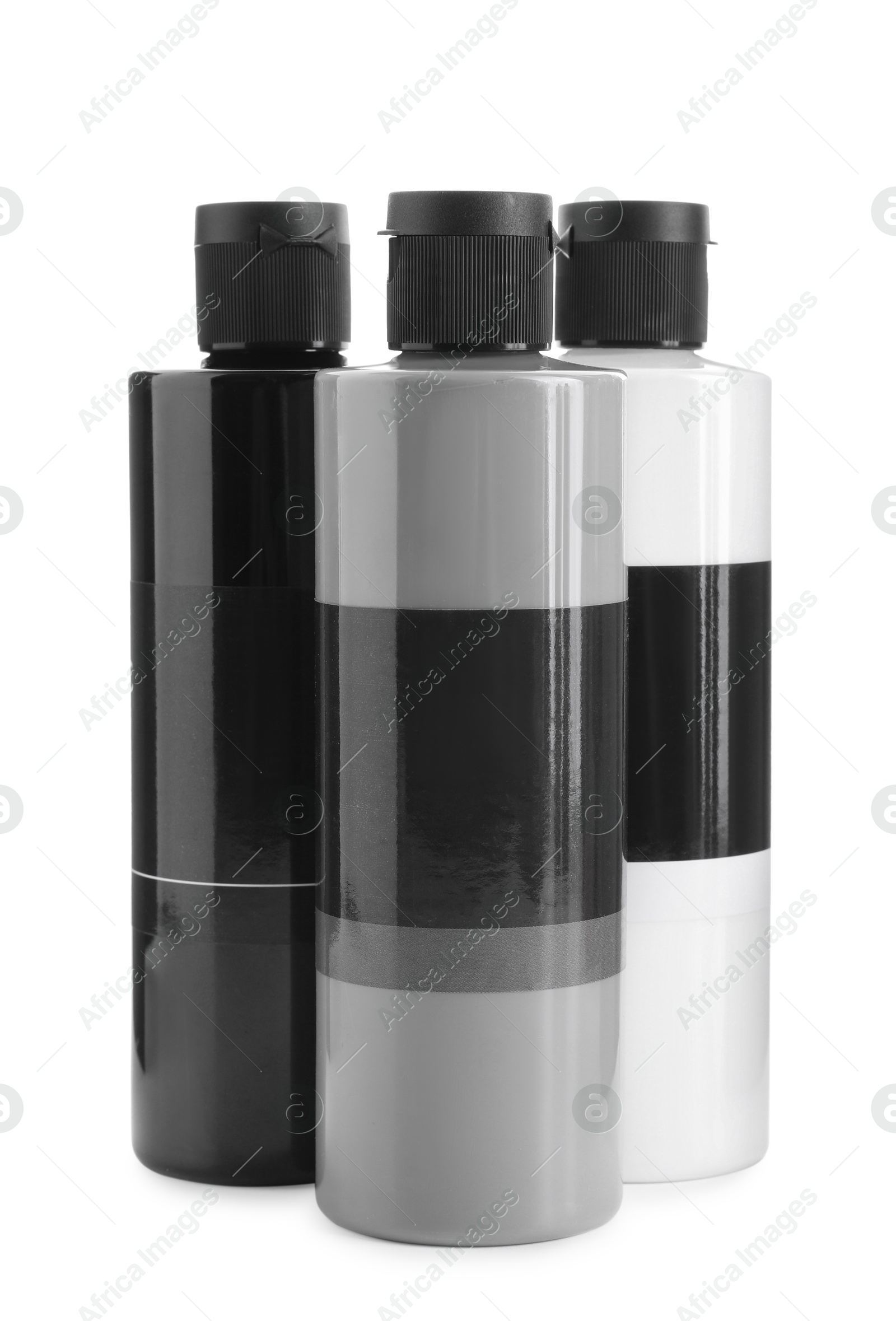 Photo of Acrylic paints of different colors in bottles isolated on white