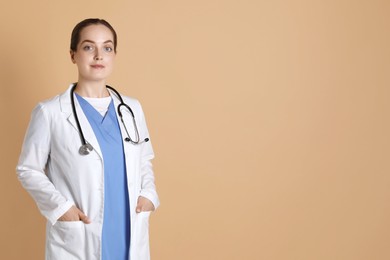 Portrait of professional nurse on dark beige background. Space for text