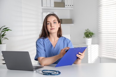 Young nurse working at desk in hospital