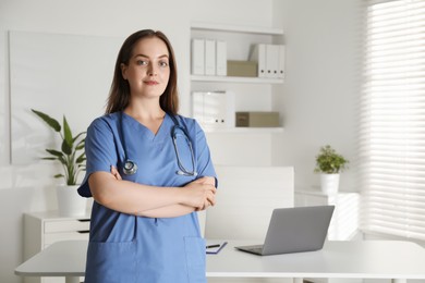 Photo of Portrait of professional nurse with stethoscope in clinic