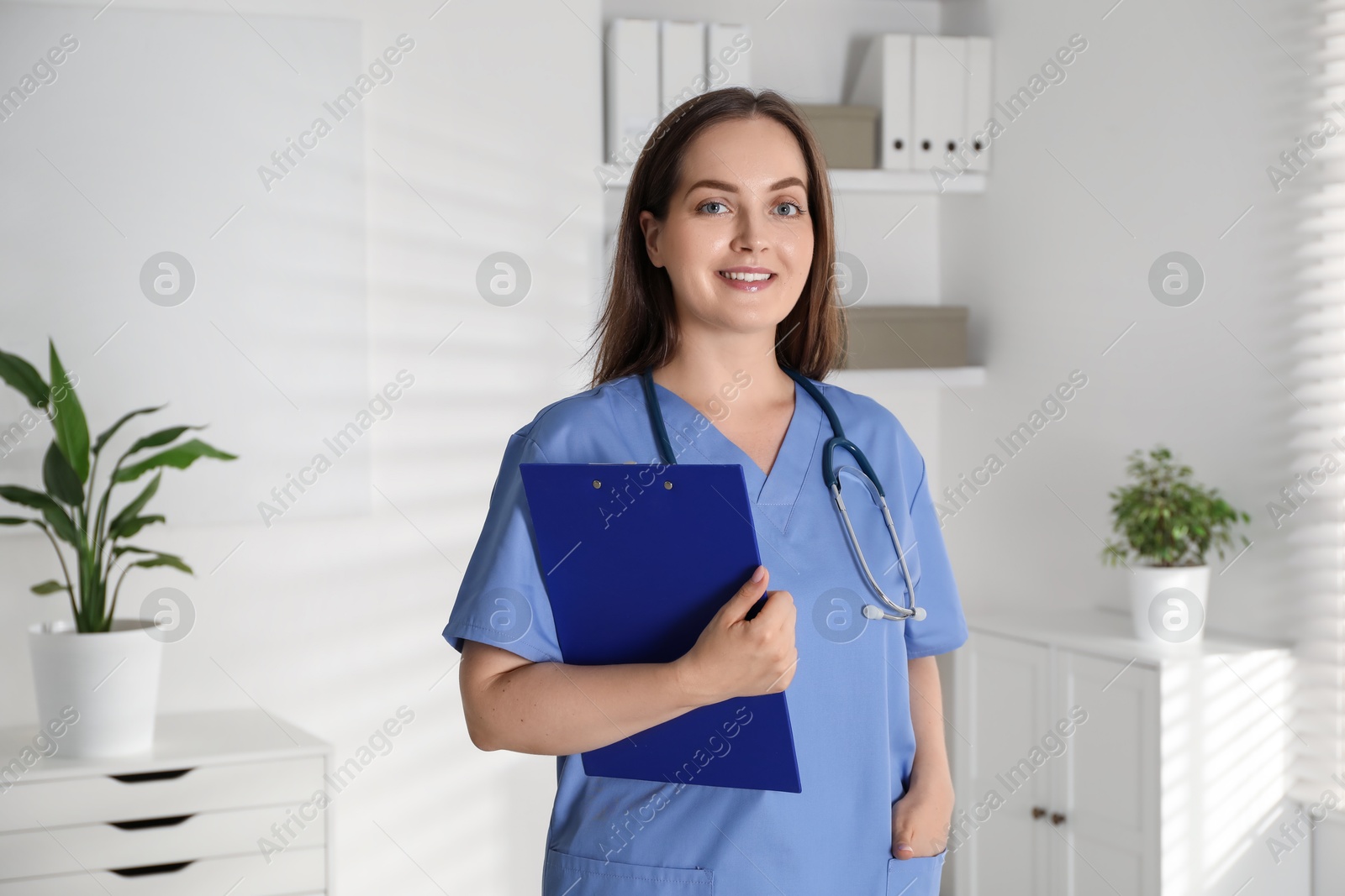 Photo of Portrait of professional nurse with clipboard in clinic