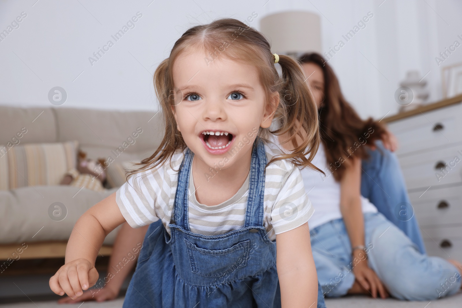 Photo of Happy family. Parents and their cute little daughter at home, selective focus