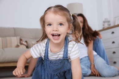 Photo of Happy family. Parents and their cute little daughter at home, selective focus