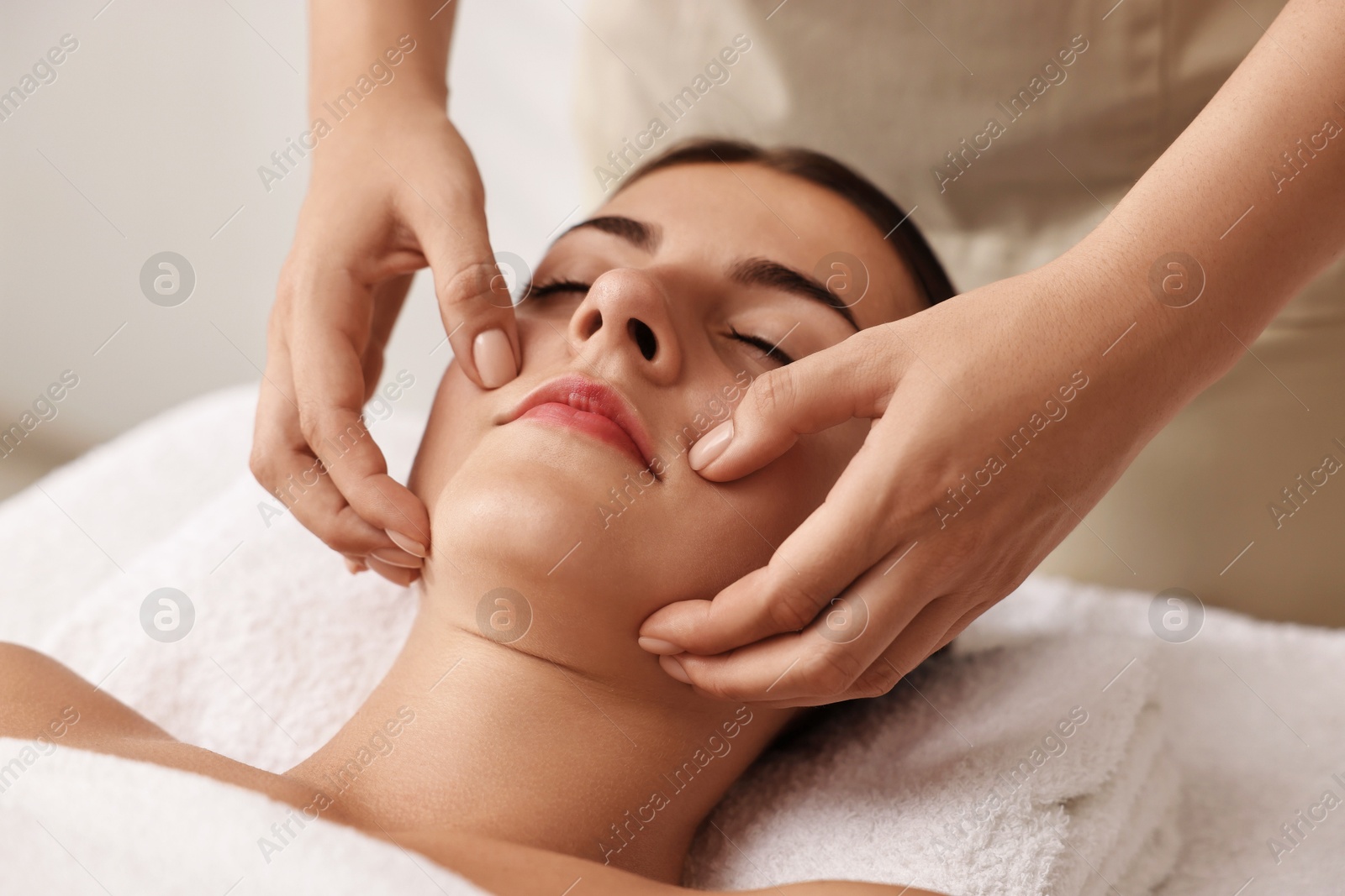 Photo of Attractive woman enjoying face massage, closeup. Beauty procedure