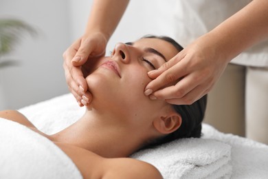 Photo of Attractive woman enjoying face massage, closeup. Beauty procedure