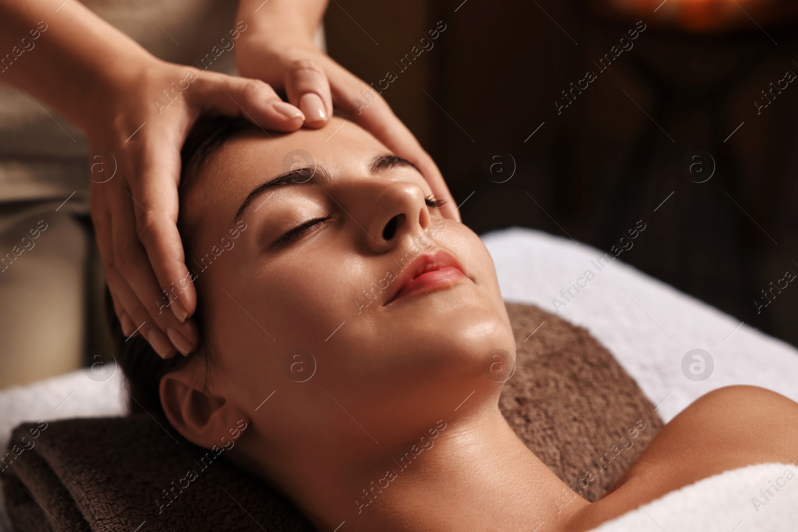 Photo of Attractive woman enjoying face massage, closeup. Beauty procedure