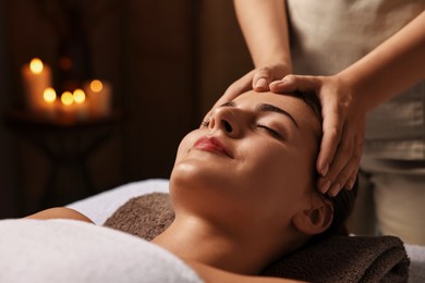 Photo of Attractive woman enjoying face massage, closeup. Beauty procedure