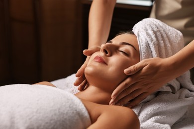 Photo of Attractive woman enjoying face massage, closeup. Beauty procedure