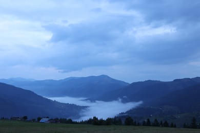 Photo of Picturesque view of beautiful mountains covered with fog