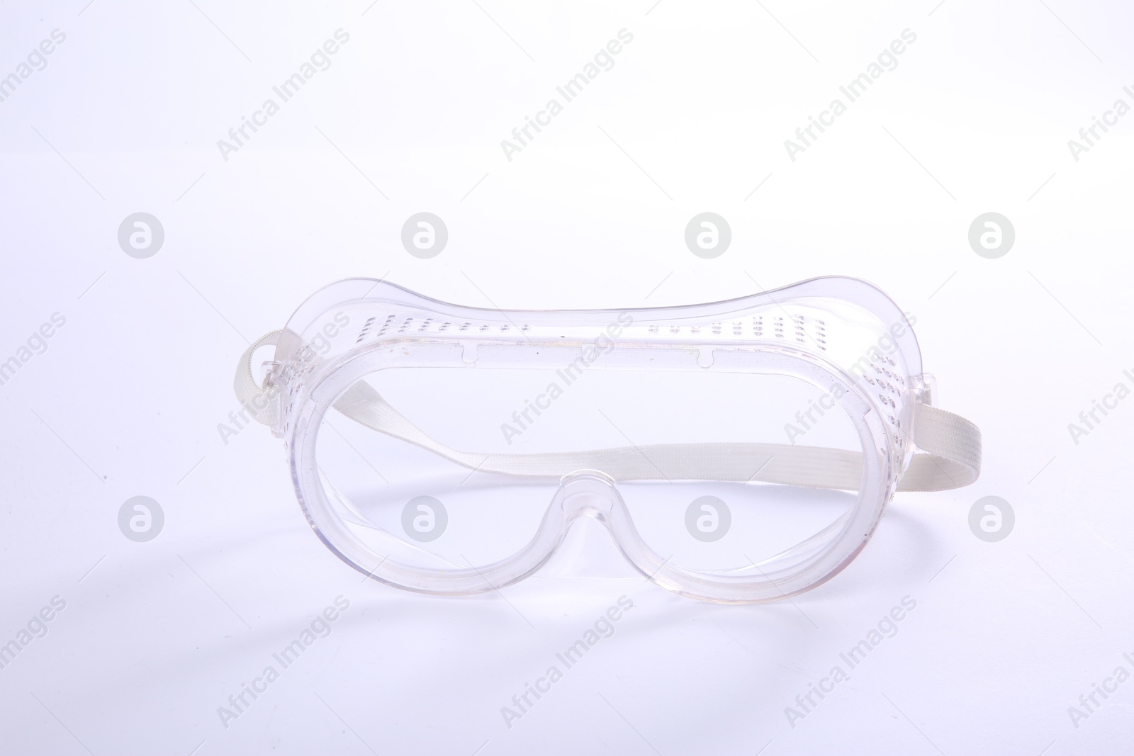 Photo of Protective goggles isolated on white. Safety equipment