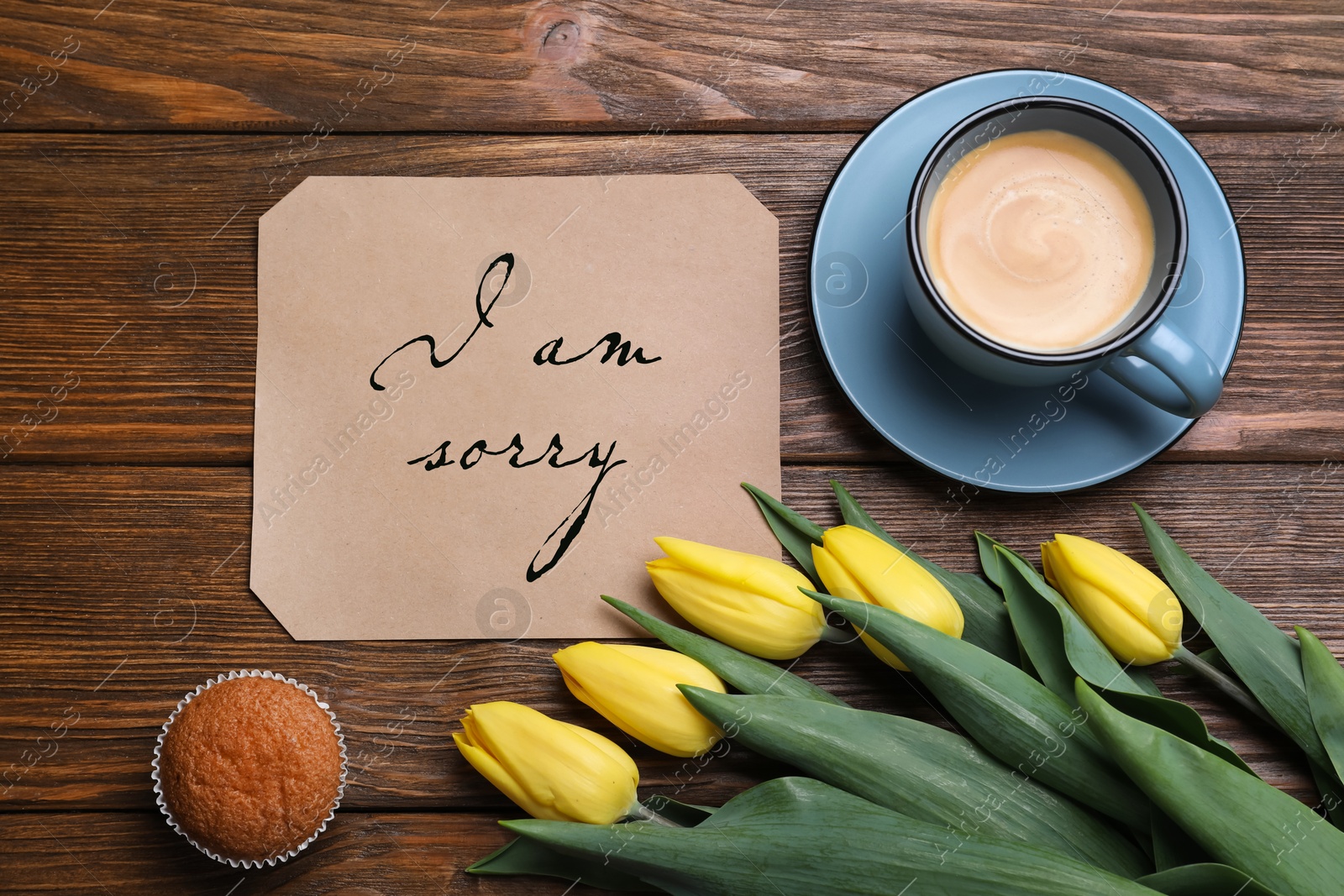 Image of Sorry card, yellow tulips, coffee and muffin on wooden table, flat lay. Space for text