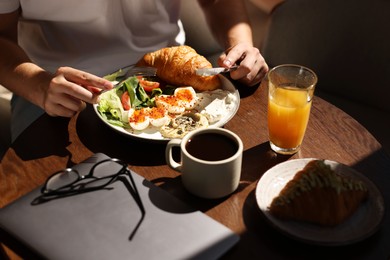 Man having tasty breakfast in cafe, closeup