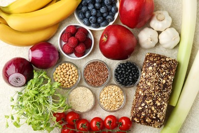 Different fresh products on grey table, flat lay. Source of prebiotics